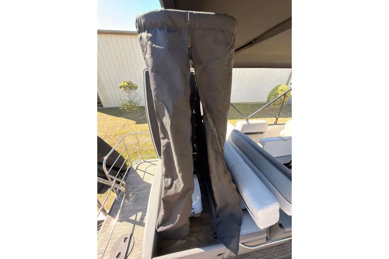 Slide: The Image of 2021 Godfrey 2286 boat interior with protective cover and seating area. - 8