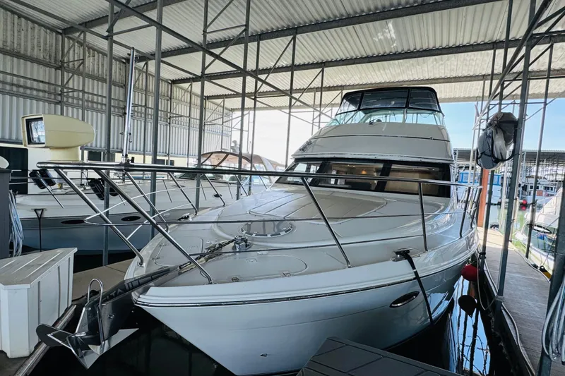 Slide: The Image of 2006 Carver 46 Voyager yacht docked in a covered marina. - 10