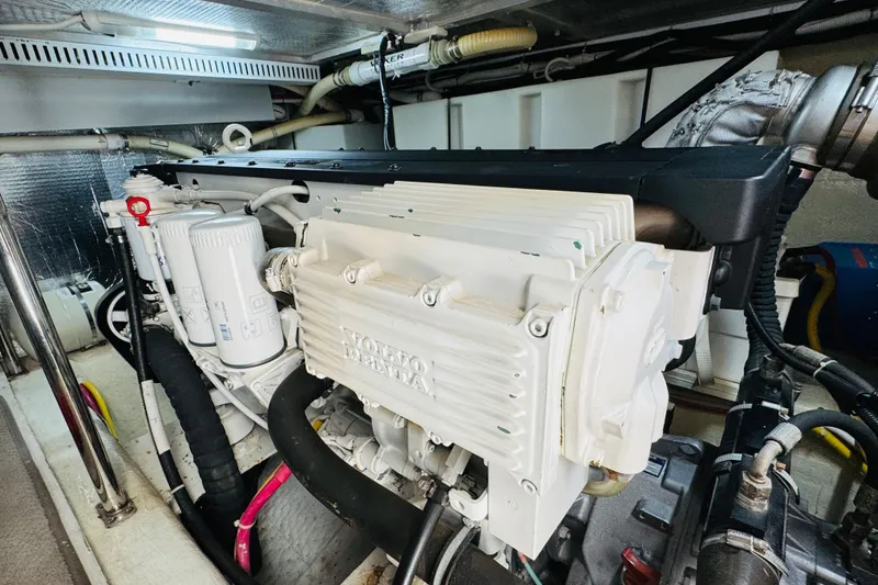 Slide: The Image of Engine room of a 2006 Carver 46 Voyager yacht, featuring a Volvo Penta engine. - 100