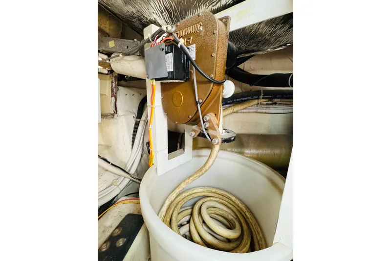Slide: The Image of Engine room of 2006 Carver 46 Voyager with coiled hose and mechanical components. - 109