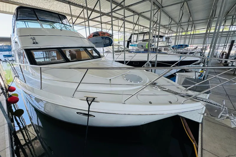 Slide: The Image of 2006 Carver 46 Voyager yacht docked in a covered marina. - 11