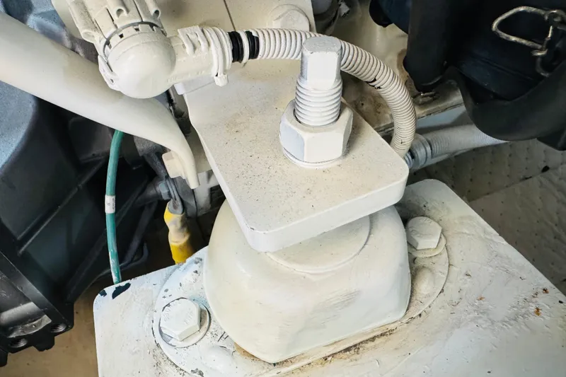 Slide: The Image of Engine component of a 2006 Carver 46 Voyager boat, featuring a bolt and wiring. - 110