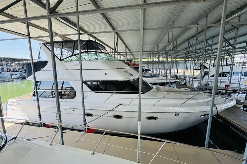 Slide: The Image of 2006 Carver 46 Voyager yacht docked in a covered marina. - 12
