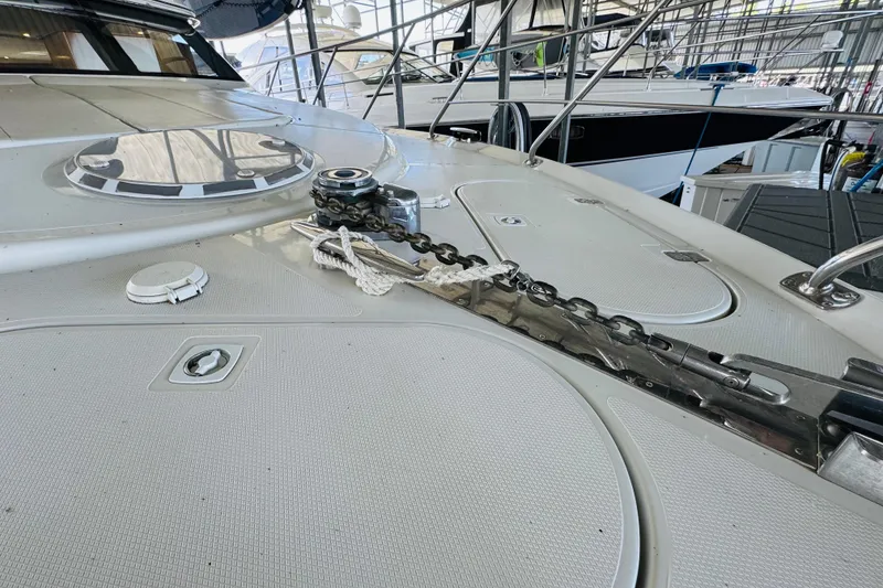 Slide: The Image of 2006 Carver 46 Voyager yacht deck with anchor chain in marina setting. - 15