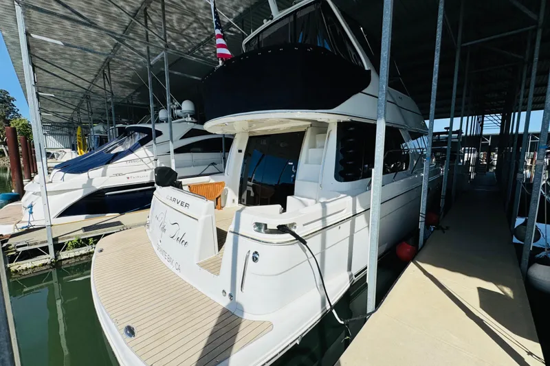 Slide: The Image of 2006 Carver 46 Voyager yacht docked in a covered marina slip. - 19