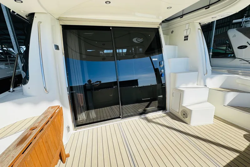 Slide: The Image of 2006 Carver 46 Voyager yacht deck with sliding glass doors and white steps. - 22