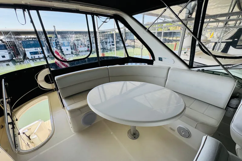 Slide: The Image of Interior of 2006 Carver 46 Voyager yacht with white seating and round table. - 29