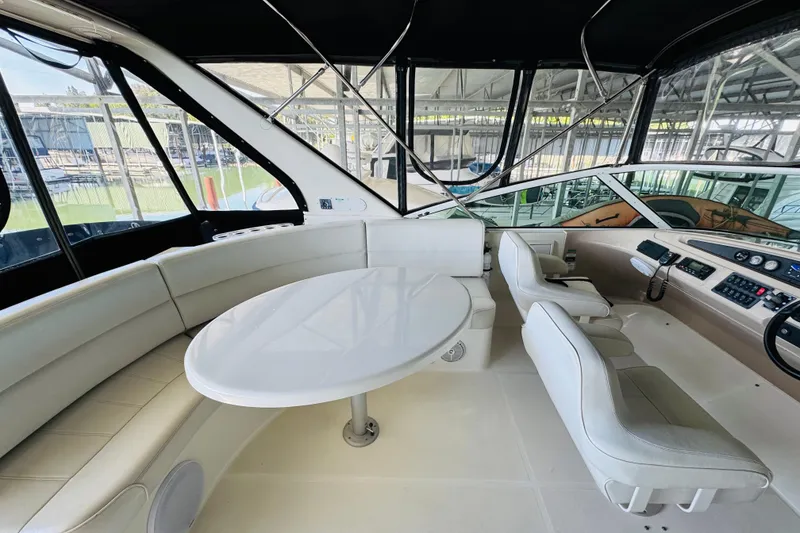 Slide: The Image of Interior of 2006 Carver 46 Voyager yacht with white seating and helm station. - 30