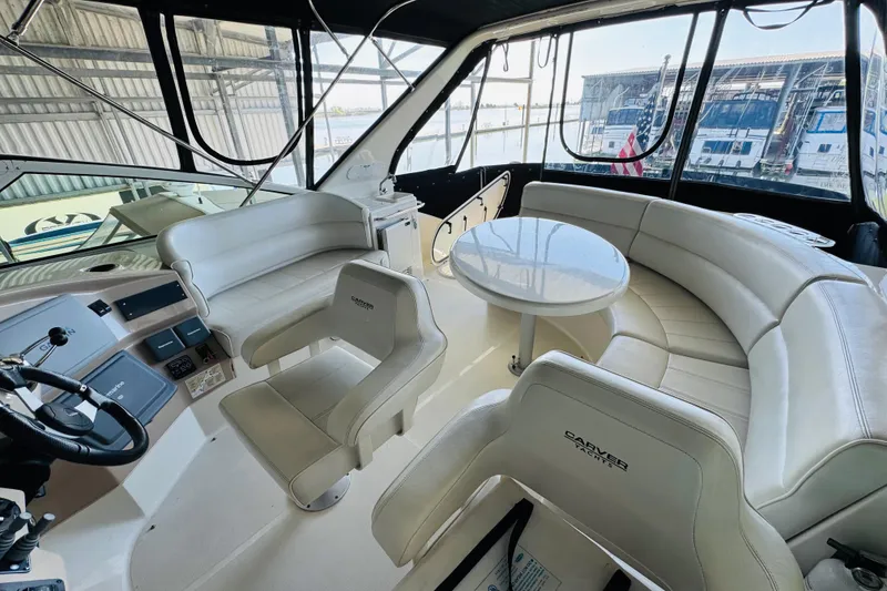 Slide: The Image of Luxurious interior of 2006 Carver 46 Voyager yacht with plush seating and helm. - 31