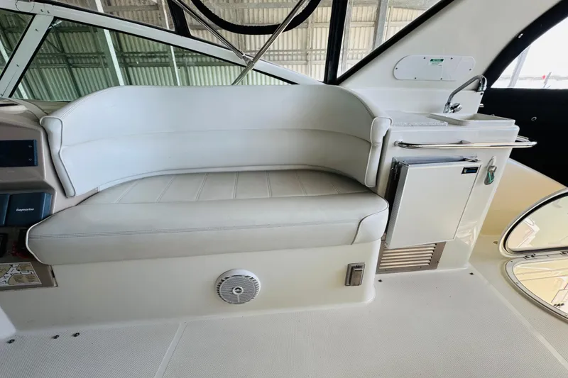 Slide: The Image of Interior of 2006 Carver 46 Voyager yacht with white seating and compact kitchenette. - 33