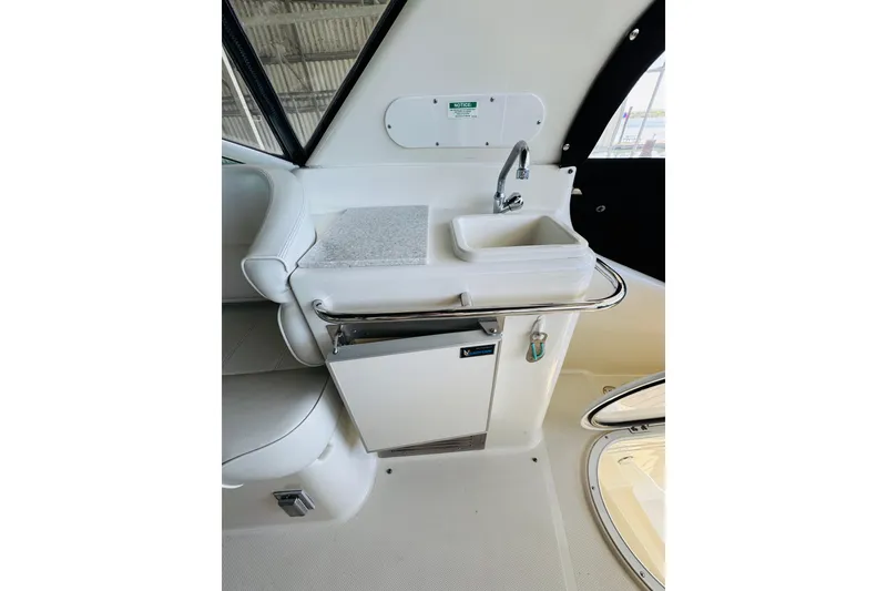 Slide: The Image of 2006 Carver 46 Voyager yacht interior with sink and seating area. - 34