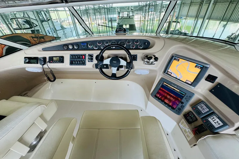 Slide: The Image of Helm of 2006 Carver 46 Voyager yacht with navigation screens and controls. - 38