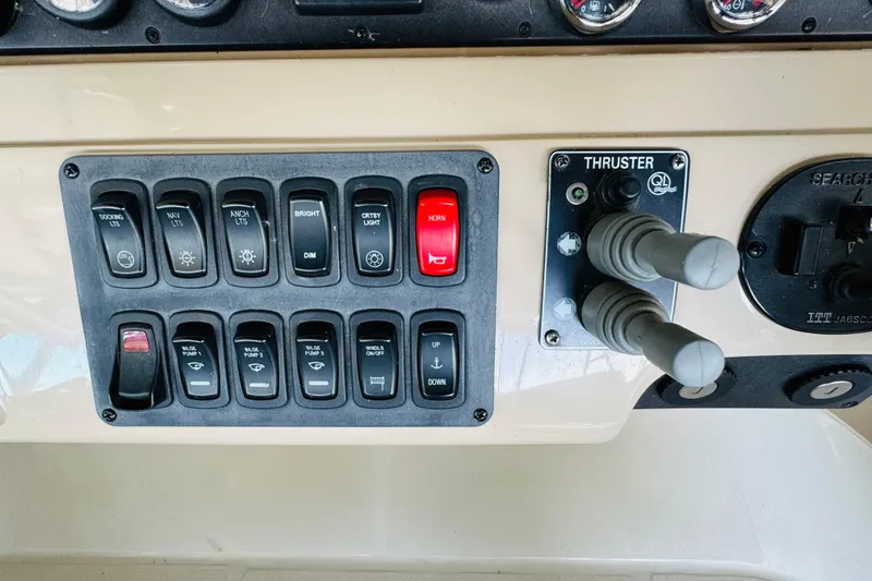 Slide: The Image of Control panel of a 2006 Carver 46 Voyager yacht with switches and thruster controls. - 40