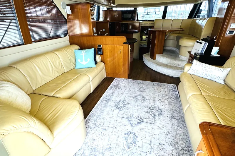 Slide: The Image of Luxurious interior of a 2006 Carver 46 Voyager yacht with leather seating and elegant decor. - 50