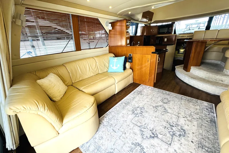 Slide: The Image of Luxurious interior of 2006 Carver 46 Voyager yacht with beige leather seating. - 51