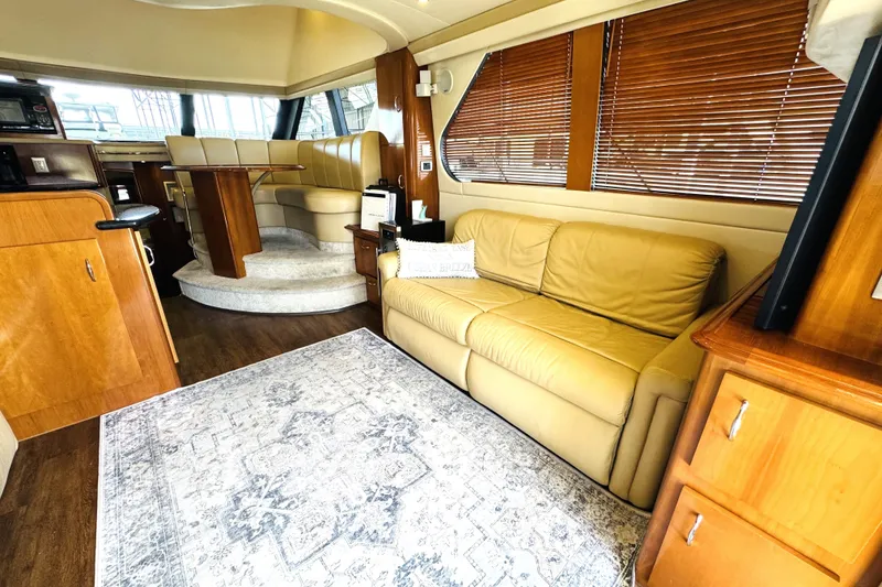 Slide: The Image of Luxurious interior of 2006 Carver 46 Voyager yacht with leather seating and elegant wood finishes. - 52