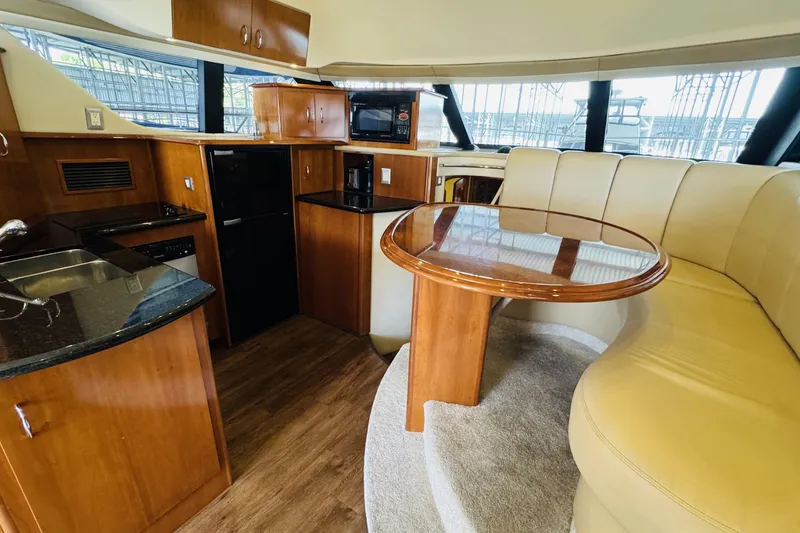 Slide: The Image of Luxurious interior of 2006 Carver 46 Voyager yacht with elegant dining area and modern kitchen. - 53