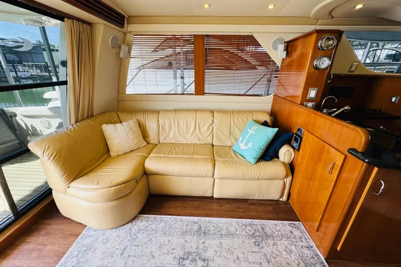 Slide: The Image of Luxurious interior of 2006 Carver 46 Voyager yacht with beige leather sofa and nautical decor. - 56