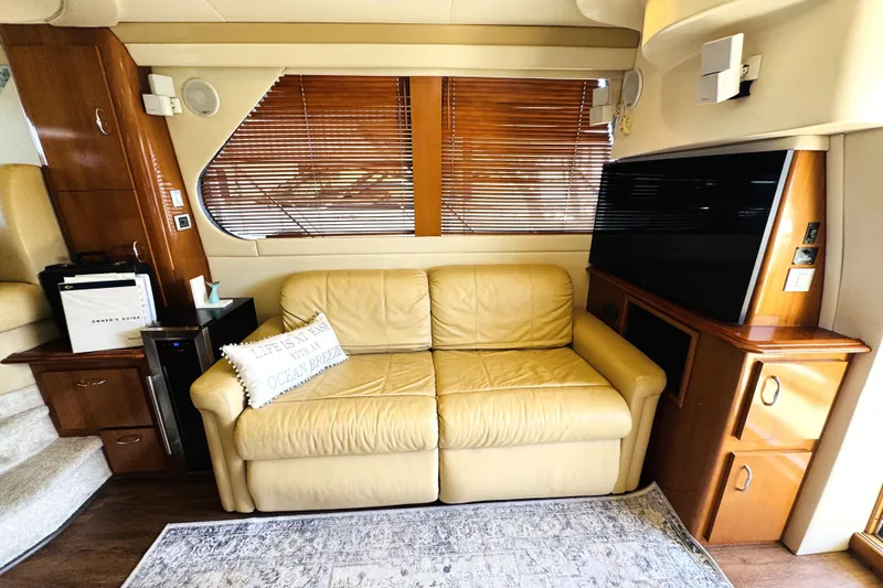 Slide: The Image of Luxurious interior of a 2006 Carver 46 Voyager yacht with leather sofa and modern amenities. - 58
