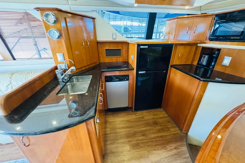 Slide: The Image of Luxurious kitchen interior of 2006 Carver 46 Voyager yacht with wood cabinetry. - 59