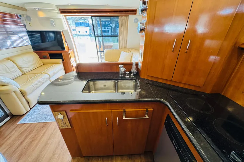 Slide: The Image of Luxurious interior of 2006 Carver 46 Voyager yacht with modern kitchen and cozy seating area. - 61