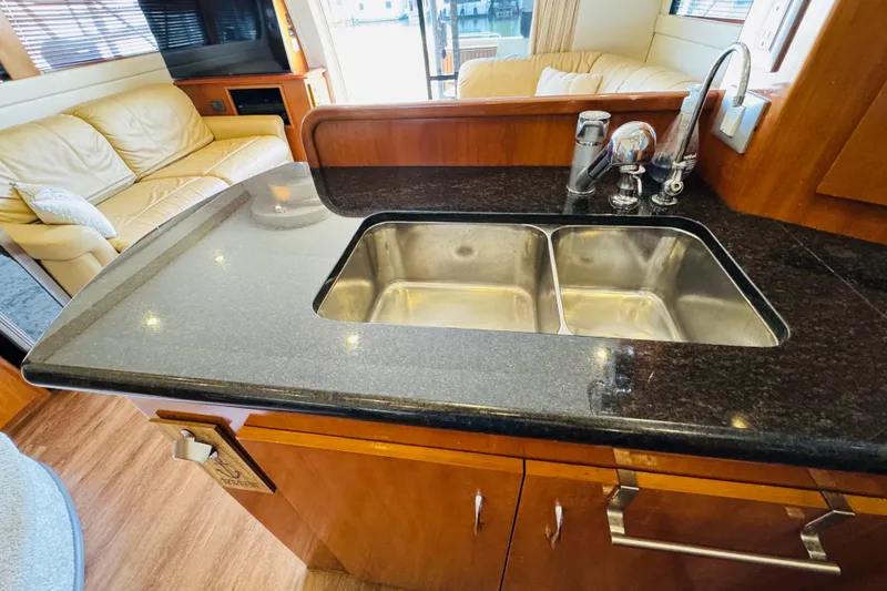 Slide: The Image of Luxurious kitchen interior of 2006 Carver 46 Voyager yacht with granite countertop and double sink. - 62