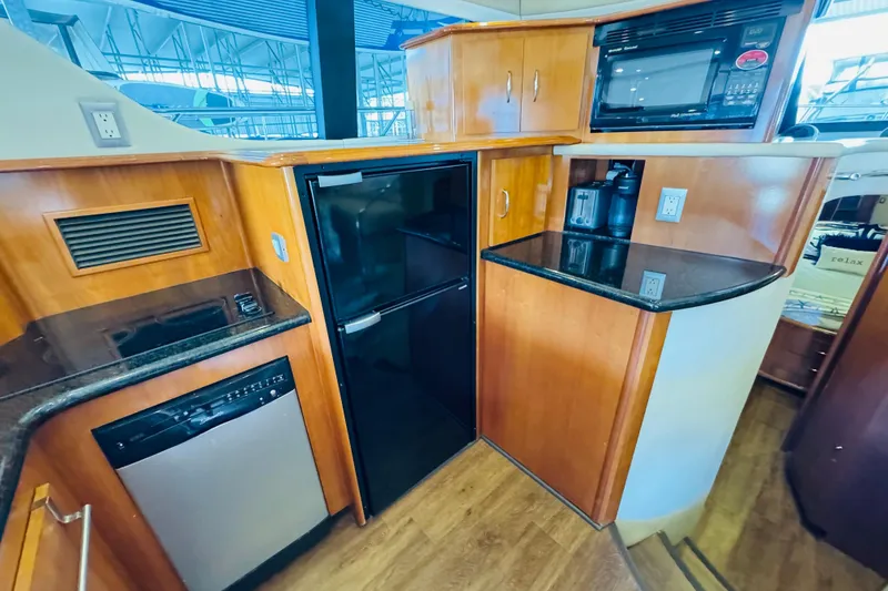 Slide: The Image of 2006 Carver 46 Voyager yacht kitchen with modern appliances and wood cabinetry. - 66