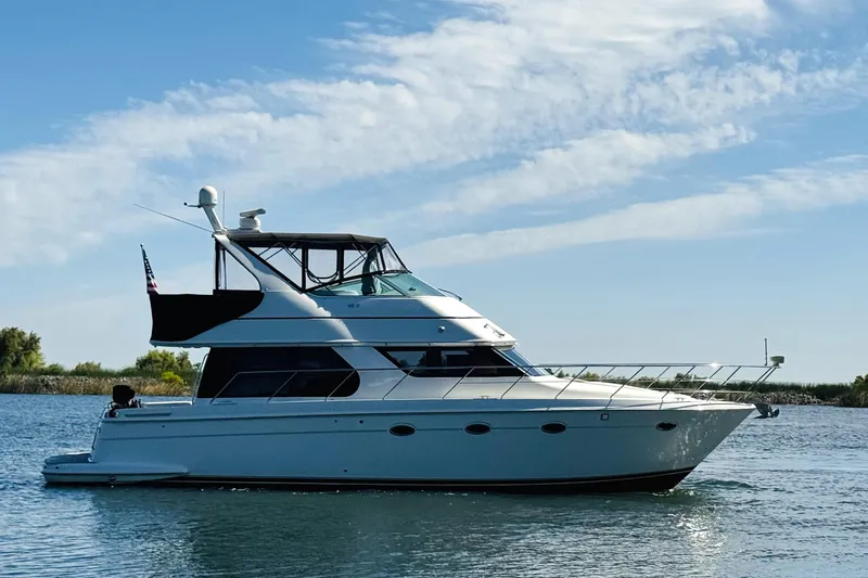 Slide: The Image of 2006 Carver 46 Voyager yacht cruising on a calm, sunny day. - 7
