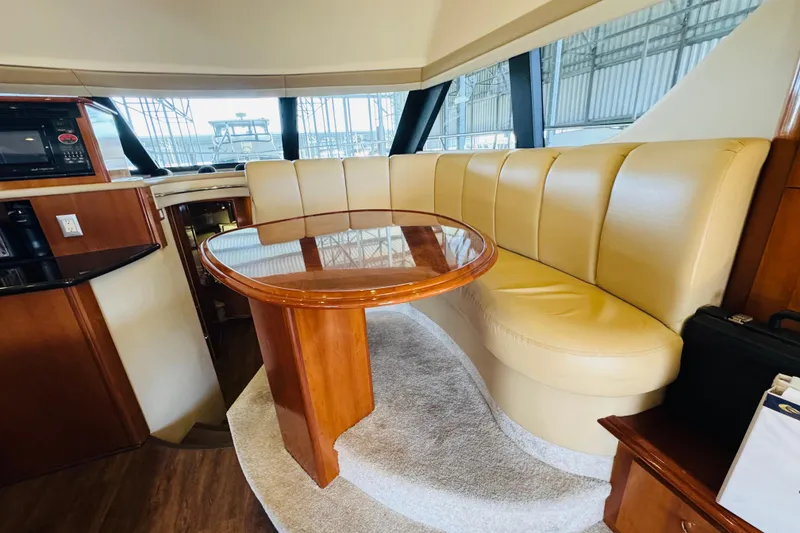 Slide: The Image of Interior of 2006 Carver 46 Voyager yacht with beige seating and wooden table. - 70