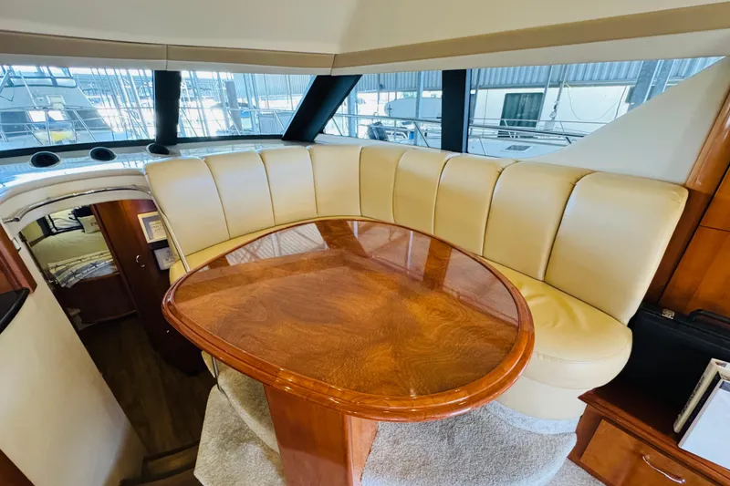 Slide: The Image of Luxurious interior of 2006 Carver 46 Voyager yacht with elegant wood table and plush seating. - 71