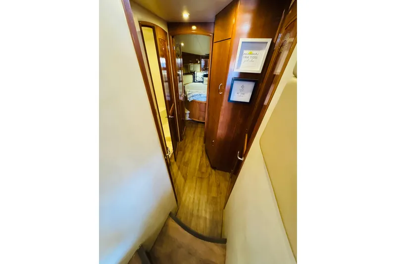 Slide: The Image of Interior hallway of 2006 Carver 46 Voyager yacht with wood flooring and framed art. - 73