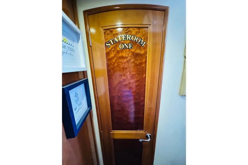Slide: The Image of Stateroom door on 2006 Carver 46 Voyager yacht, featuring elegant wood finish. - 74
