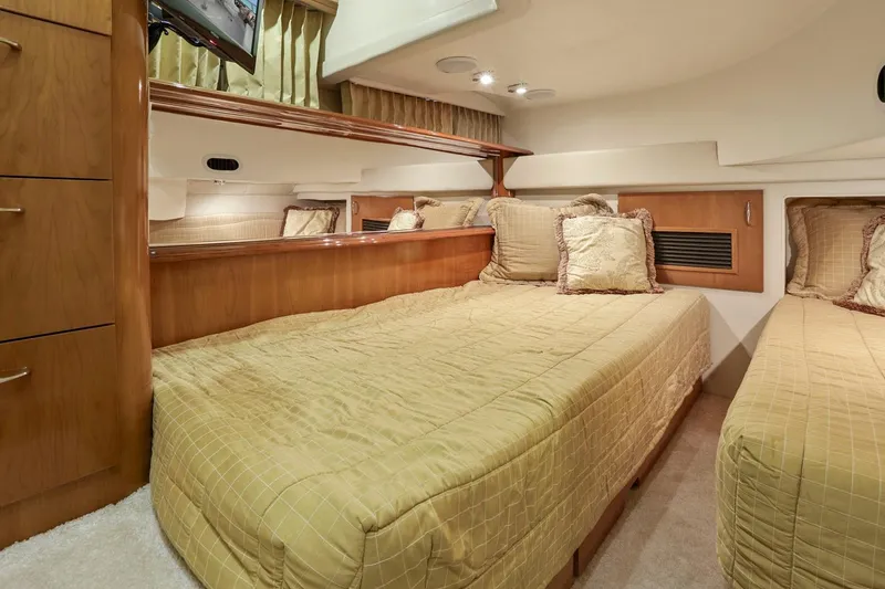 Slide: The Image of Luxurious cabin interior of 2006 Carver 46 Voyager yacht with twin beds and elegant decor. - 75