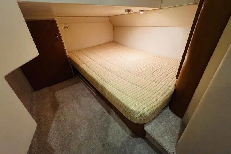 Slide: The Image of 2006 Carver 46 Voyager cabin interior with cozy bed and carpeted floor. - 78