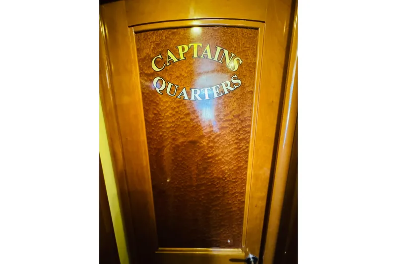 Slide: The Image of Captain's Quarters door on 2006 Carver 46 Voyager yacht, featuring elegant wood finish. - 81