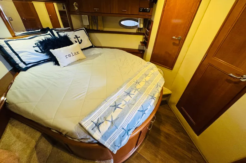Slide: The Image of Cozy bedroom in 2006 Carver 46 Voyager yacht with nautical-themed decor. - 84