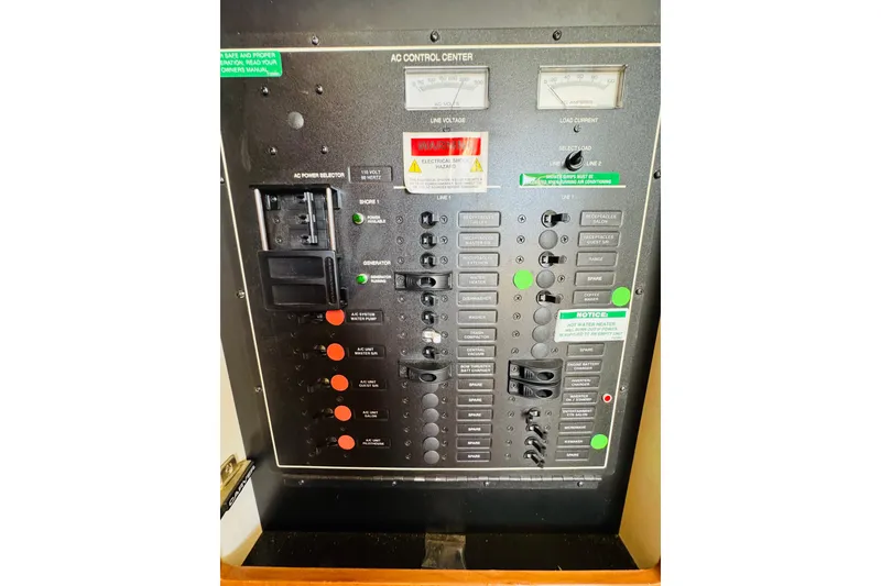 Slide: The Image of Electrical control panel of a 2006 Carver 46 Voyager yacht, featuring various switches and indicators. - 88
