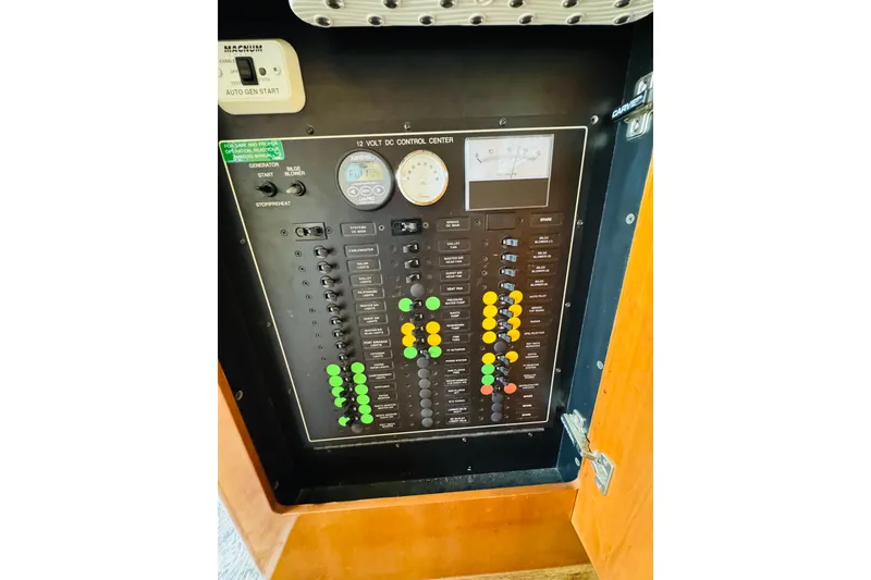 Slide: The Image of Electrical control panel of a 2006 Carver 46 Voyager yacht, featuring switches and gauges. - 89