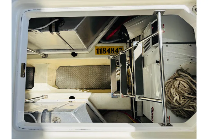 Slide: The Image of Engine compartment of 2006 Carver 46 Voyager with metal ladder and storage space. - 92