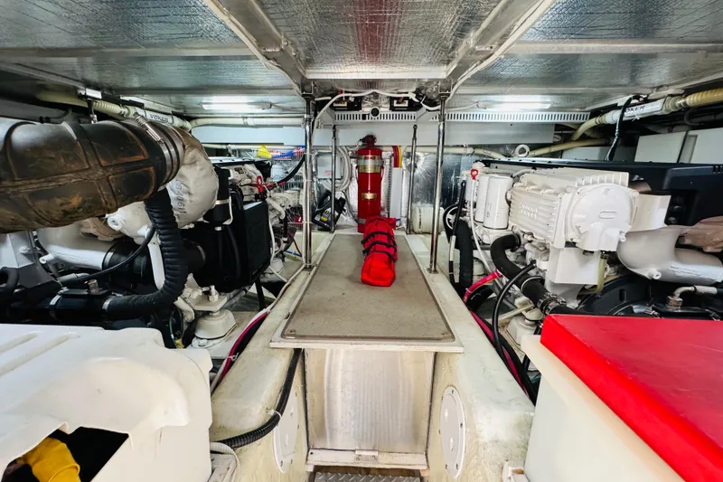 Slide: The Image of Engine room of a 2006 Carver 46 Voyager yacht, featuring mechanical components and equipment. - 93