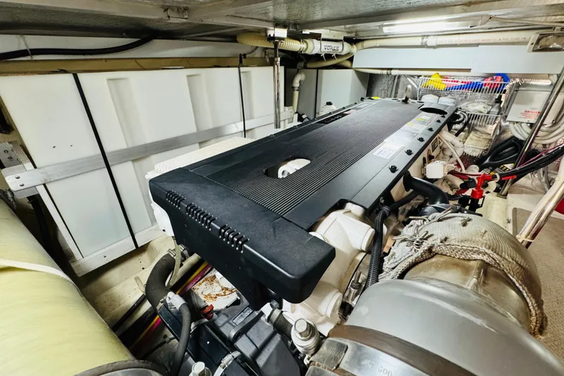 Slide: The Image of Engine room of a 2006 Carver 46 Voyager yacht, showcasing detailed machinery. - 94