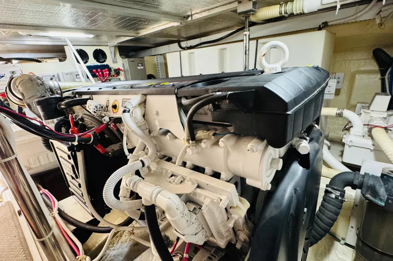 Slide: The Image of Engine room of a 2006 Carver 46 Voyager yacht, showcasing detailed machinery and components. - 97