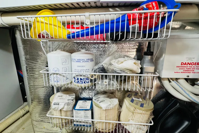 Slide: The Image of Storage shelves with boat maintenance supplies on a 2006 Carver 46 Voyager. - 99