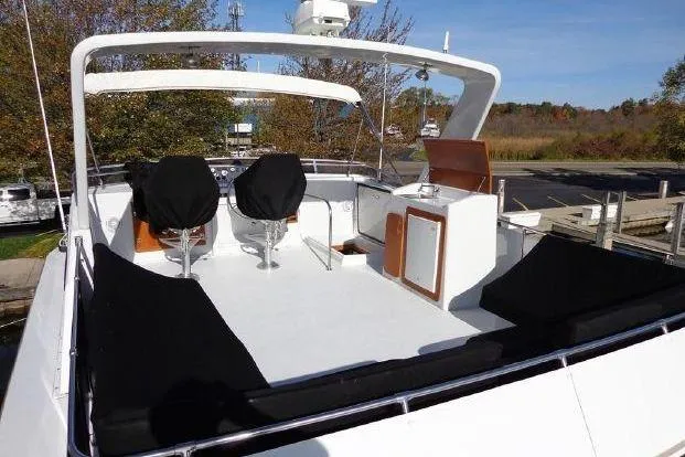 Slide: The Image of 1988 Chris-Craft 501 Motor Yacht with spacious deck, covered seating, and outdoor kitchenette. - 6