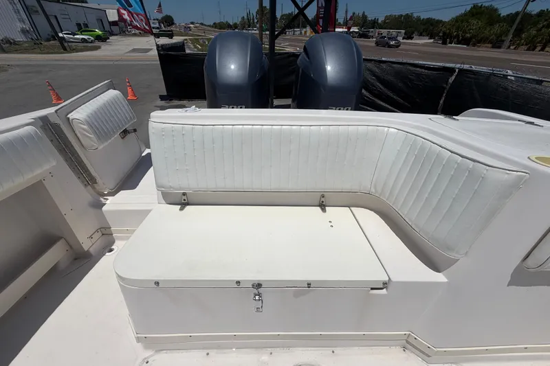 Slide: The Image of 1994 Grady-White Sailfish 272 boat interior with white seating and dual outboard motors. - 103