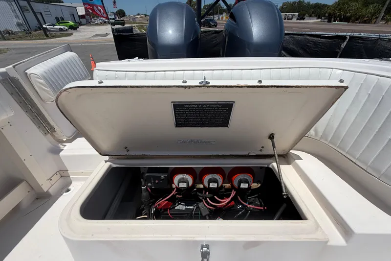 Slide: The Image of Open battery compartment on a 1994 Grady-White Sailfish 272 boat, showcasing wiring and switches. - 104