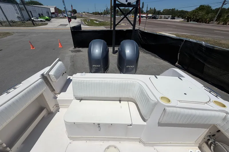 Slide: The Image of 1994 Grady-White Sailfish 272 boat with twin 200 horsepower engines, docked on land. - 106