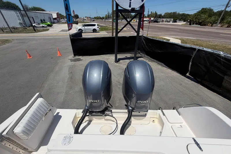 Slide: The Image of 1994 Grady-White Sailfish 272 with dual 200 horsepower outboard engines, parked outdoors. - 108