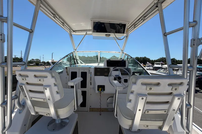 Slide: The Image of 1994 Grady-White Sailfish 272 boat cockpit with dual seats and steering wheel. - 26