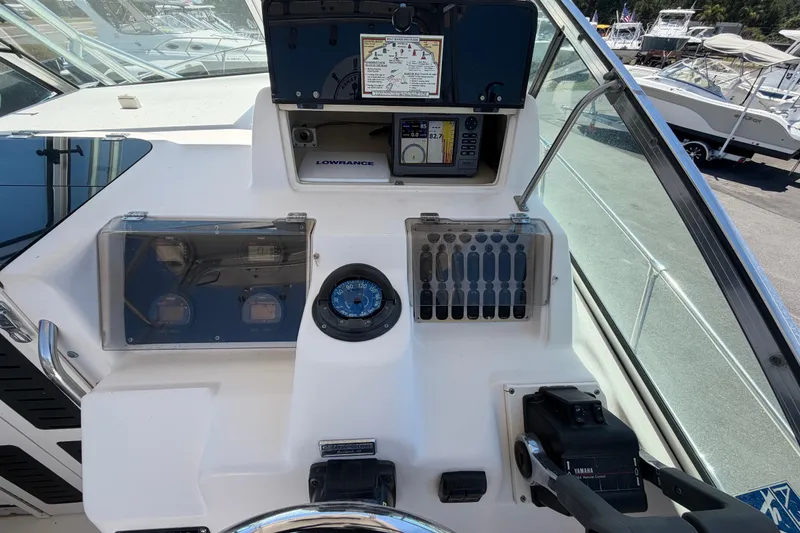 Slide: The Image of 1994 Grady-White Sailfish 272 boat dashboard with navigation instruments and controls. - 29